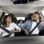 Happy african american family enjoying car ride together